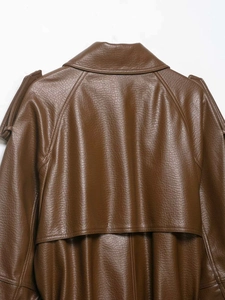 Detailed back view of a dark brown faux leather jacket with storm flap and epaulettes