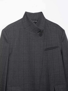 Close-up of dark grey pinstripe suit jacket with high collar and DEFEIR label