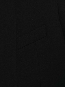 Macro shot of the black woven fabric texture and seamless slanted pocket on this blazer