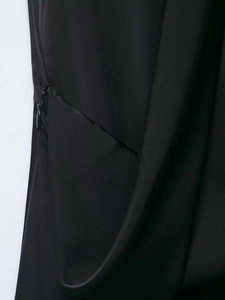 Détail d'une fermeture éclair invisible sur une robe longue en satin noir élégante