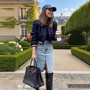 Chic navy cropped bomber jacket styled with a slit denim midi skirt and black leather boots