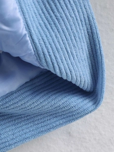 Macro shot of light blue corduroy fabric detail and smooth silk-like inner lining