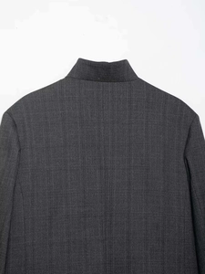 Detail shot of charcoal gray textured blazer featuring a stand-up collar and vertical weave