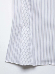 Detail view of striped poplin shirt showing fine sewing lines and fabric texture