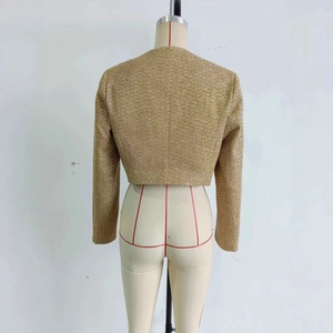 Back view of a gold cropped tweed jacket with long sleeves and shimmering metallic texture