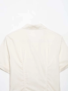 Close-up of poplin shirt back view showing the collar and waist stitching details