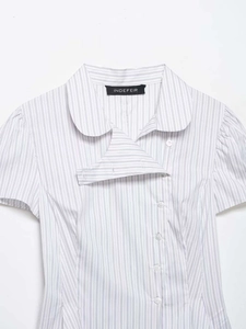 Detail of blue striped poplin shirt showing Peter Pan collar and offset buttons