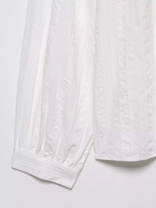Macro view of white seersucker fabric texture with vertical stripes and stitched hem details