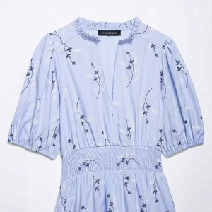 Light blue floral V-neck dress with puff sleeves and elastic waist for a slim fit