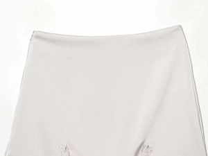 Detailed shot of satin mini skirt with invisible zipper and delicate lace hem edges