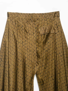 Detail view of the back pocket and waist structure on these brown snakeskin wide-leg pants