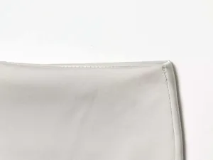 Close-up of the delicate light gray woven fabric and precise stitching on the mini skirt