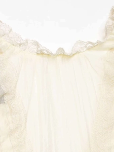 Detail of delicate lace embroidery and vertical pleated translucent fabric on sleeve