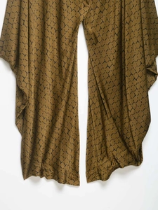 Detail of snake print wide-leg pants in brown and olive with a high-quality drape finish