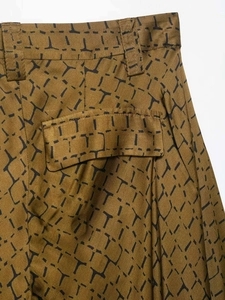 Detailed view of snake-patterned wide-leg pants featuring a functional flap pocket and belt loops