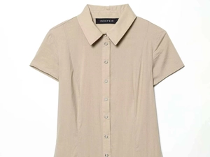 Detail view of beige button-down shirt with silver metal snaps and tailored princess seams