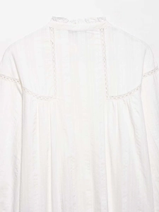 Detail of vintage white lace shirt featuring a standing collar and ruffled lace trim accents