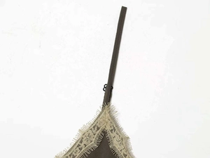 Detail of olive green dress featuring lace trim and adjustable spaghetti straps