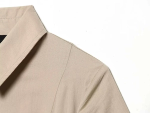 Detail shot of the tailored collar and shoulder stitching on a khaki summer dress