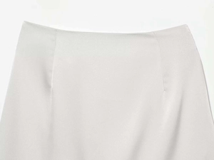 Detailed view of grey lace skirt fabric with clean seams and elegant silk-like texture