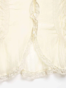 Detailed macro shot of cream V-neck blouse with lace trim and white buttons detail