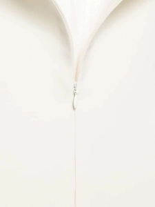 Detailed macro view of white puff sleeve shirt with high quality invisible zipper closure