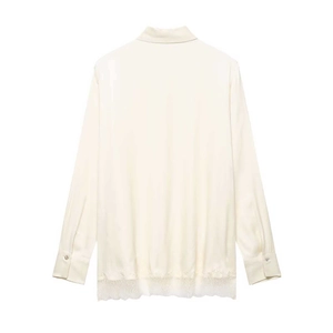 Elegant off-white satin long-sleeve blouse featuring a delicate lace patchwork hem design