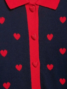 Detail of navy knit cardigan with red heart jacquard and matching heart buttons