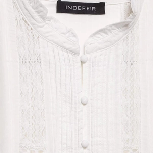 White vintage lace shirt featuring high collar ruffles and delicate button details
