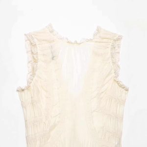 Elegant ivory V-neck sleeveless lace blouse with sheer tulle and ruffled textures