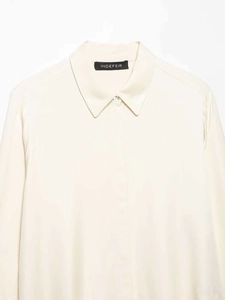 Close-up of a cream satin long sleeve shirt featuring a classic lapel collar and brand label