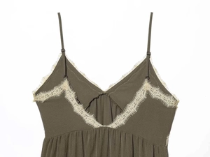 Detail of olive green V-neck dress with delicate beige eyelash lace trim and thin straps
