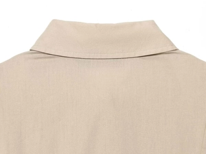 Detail of the high-quality stitching and collar texture of a beige short sleeve dress