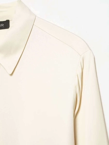 Detailed close-up of cream satin shirt collar with premium fabric texture and elegant stitching