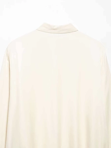 Detail of the back collar and smooth satin fabric on this elegant cream long sleeve blouse