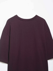 Dettaglio del top in raso viola scuro con pizzo e texture in tessuto a maglia liscia