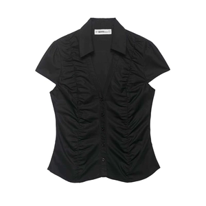 Vintage black polka dot short sleeve shirt with ruched waist and deep V-neck design