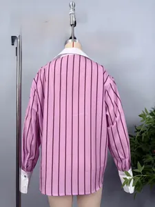 Back view of loose fit striped shirt with contrast white collar and wide cuffs