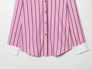 Detailed shot of striped shirt featuring white contrast cuffs and brown buttons