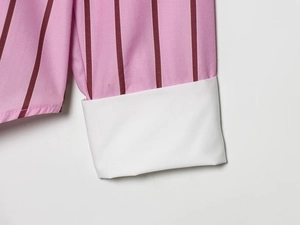 Detail of pink striped shirt sleeve with contrasting white cuffs and fine stitching