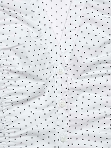 Close-up of V-neckline and button detail on white polka dot short sleeve shirt
