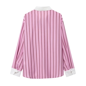 Detailed view of striped pink shirt with contrasting white collar and buttoned cuffs