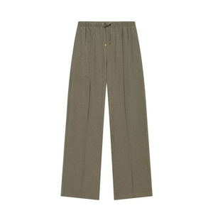 Detail of olive green trousers showing drawstring elastic waist and vertical seam lines