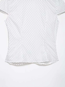Detailed macro view of the white polka dot vintage short sleeve blouse fabric texture