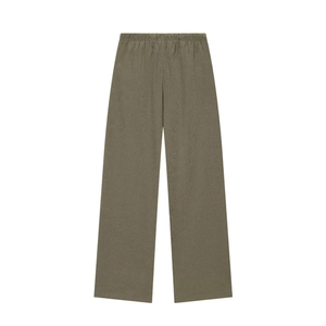 Detail of olive green wide-leg trousers with natural linen texture and elastic waist