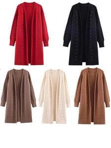Detail view of colorful knit cardigans with rhinestone accents and lantern sleeves