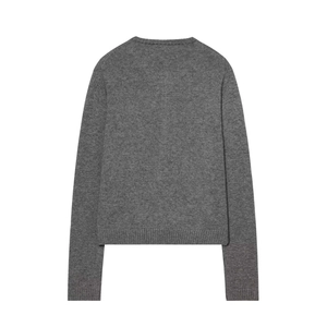 Detail view of the back of a grey knit cardigan with ribbed cuffs and a plush wool texture