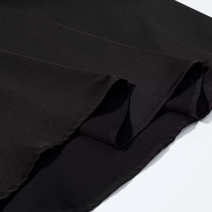 Detail shot of black chiffon dress fabric showing high-quality stitching and texture