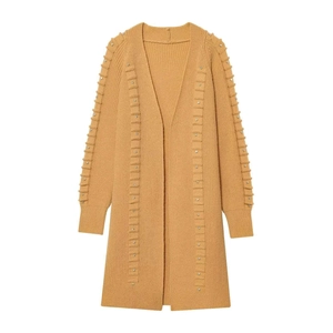 Detail of ginger yellow knit cardigan with rhinestone studs and vertical rib texture