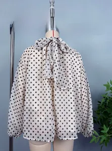Rear view of vintage polka dot chiffon blouse with a large bow tie on high neck collar
